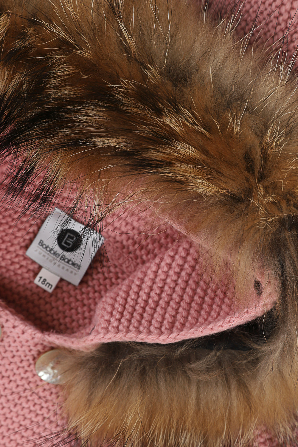 Bobble Babies knitted jacket in peony pink / natural hood trim